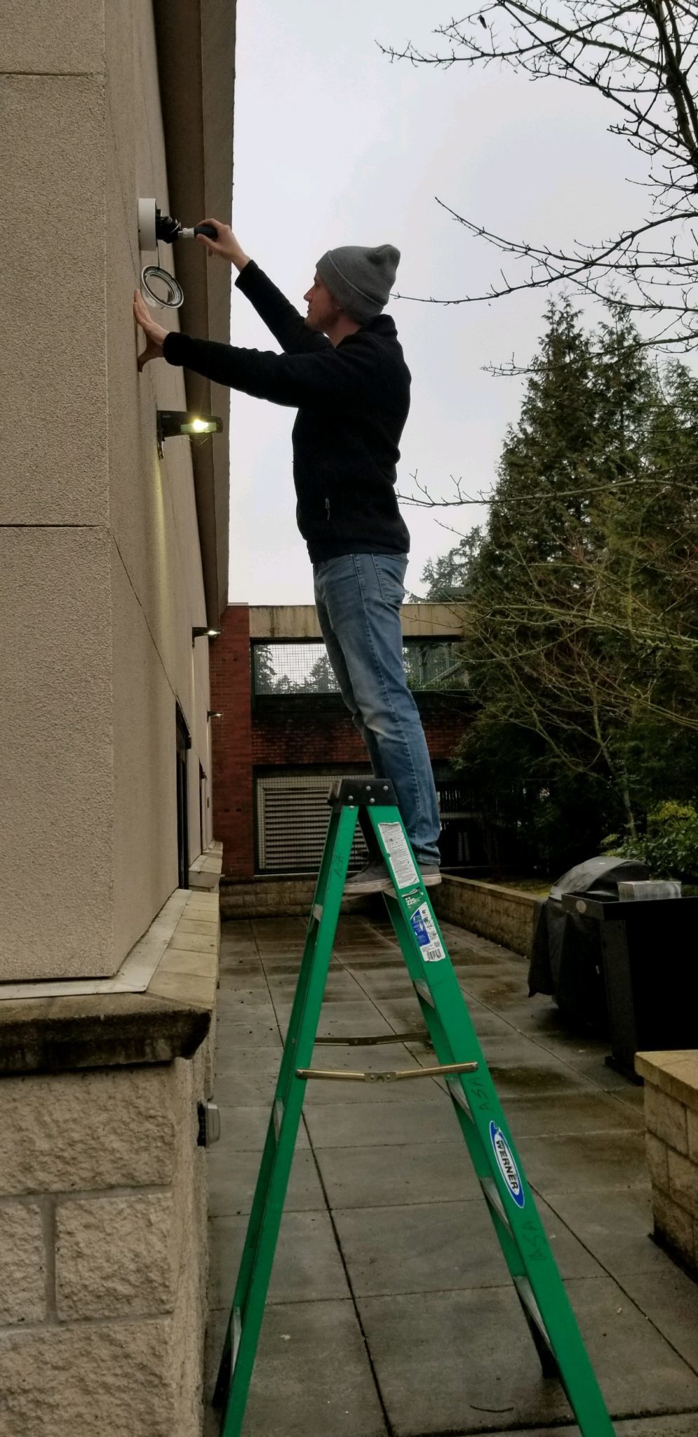 Absolute Security Alarms surveillance installer aiming a camera for a client.